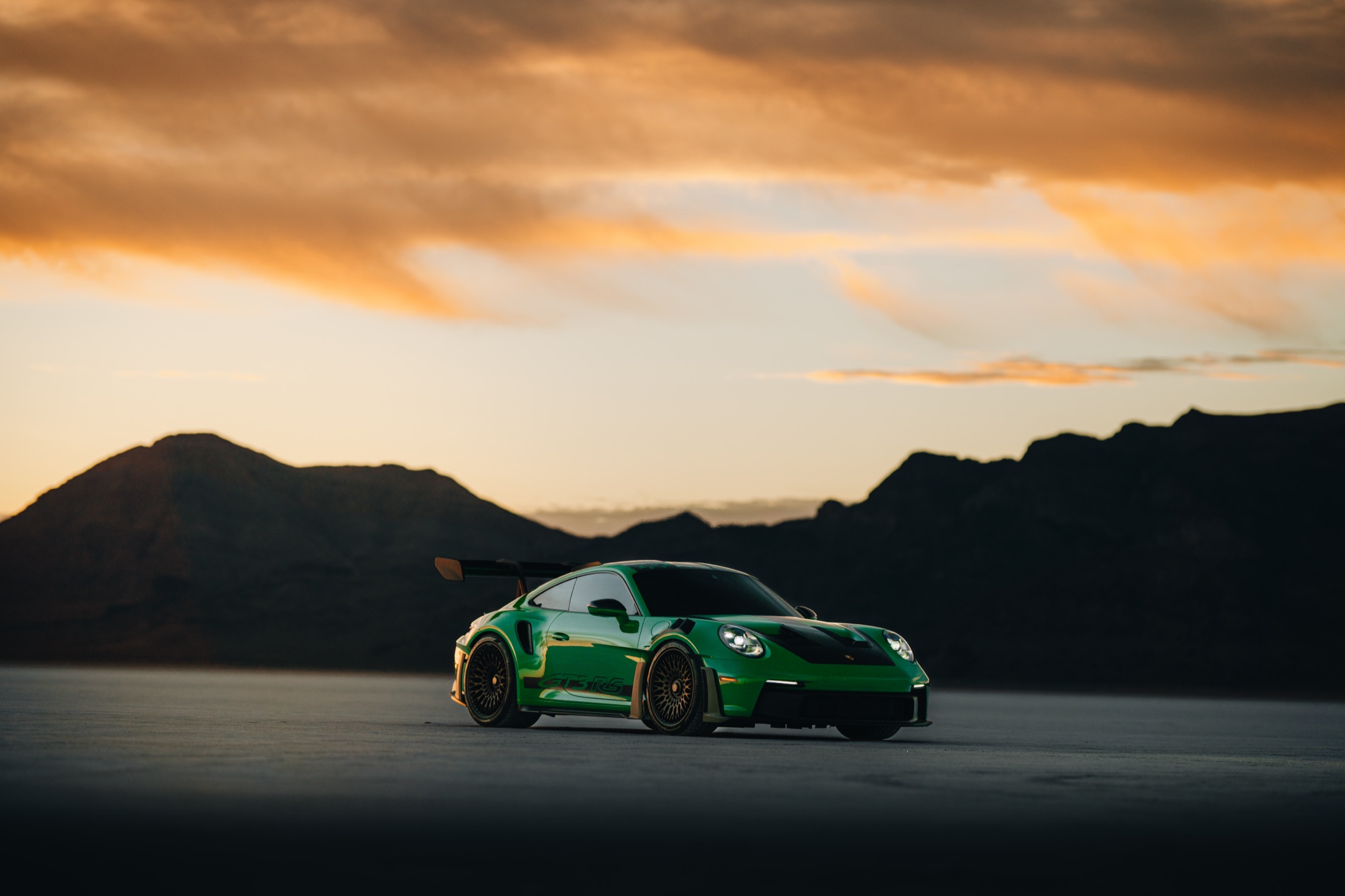 Green Porsche GT3 at sunset